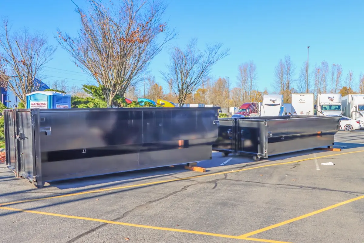 Professional dumpster rental service with roll-off container on residential driveway in East Cocalico